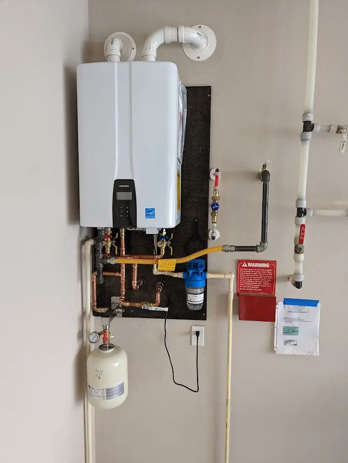 Professional plumber installing copper piping in a Brownstown home